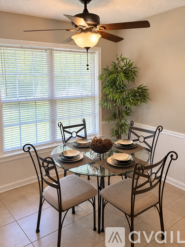 A dining room with a glass table and chairs.