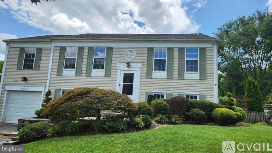 A house with a white door and windows is for sale.