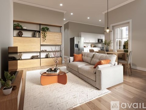 A modern living room with a white sofa and a coffee table.