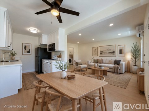 A modern kitchen with a dining table and chairs.