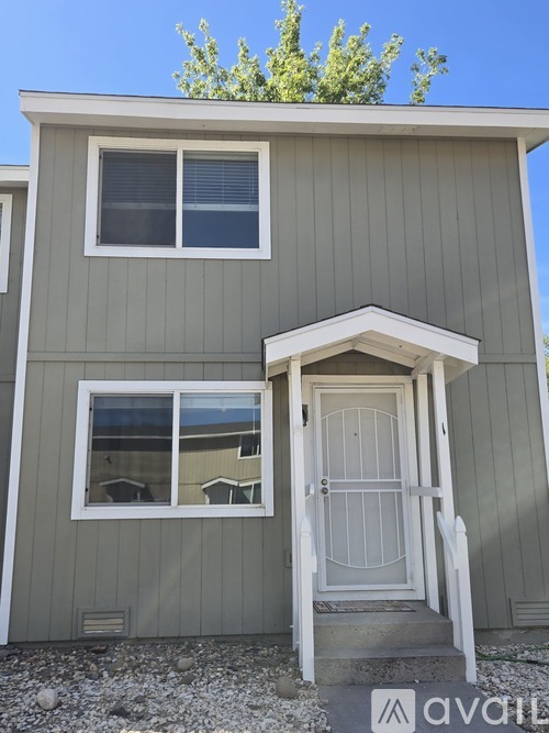 A small house with a white door and a window.