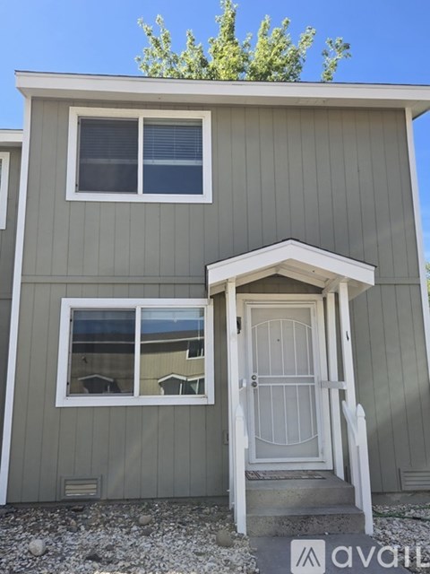 A small house with a white door and a window.