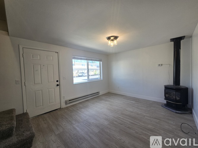 A room with a wood stove and a window.