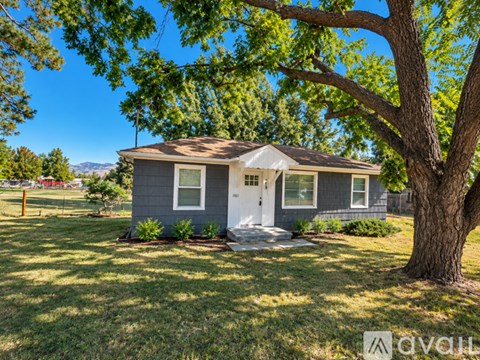 A house with a tree in front of it.