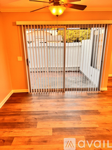 A room with a sliding door leading to a balcony.