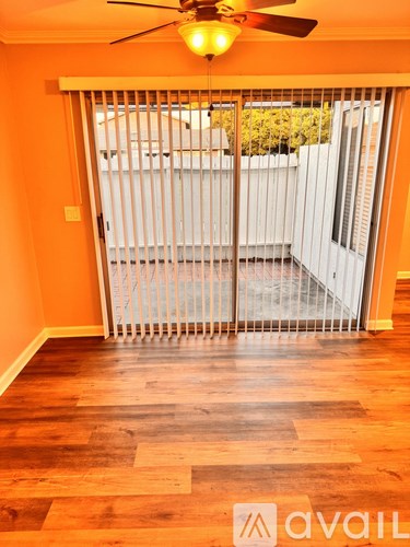 A room with a sliding door leading to a balcony.