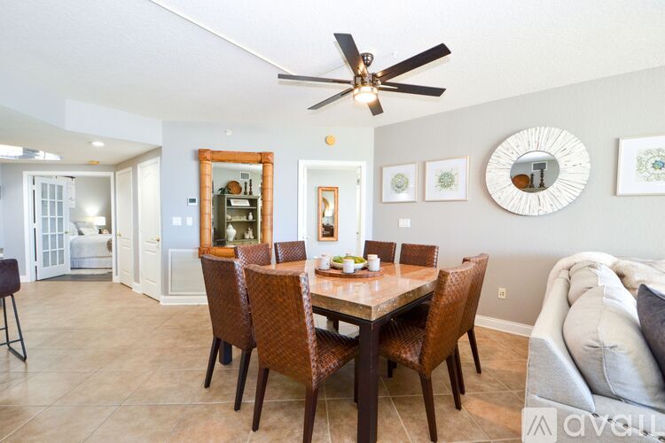 A dining room with a table set for four.
