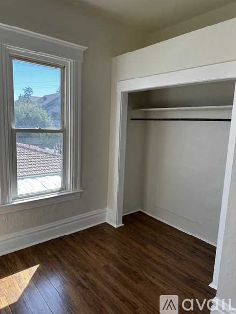 A room with a window and a white closet.