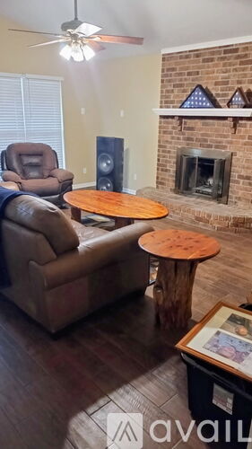 A living room with a fireplace and a chair.