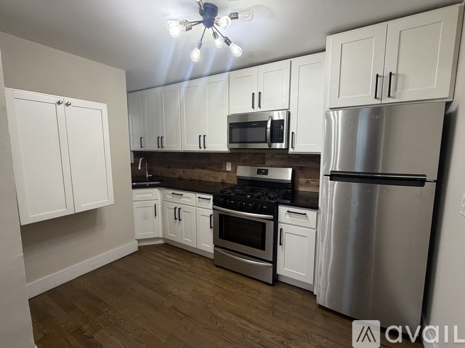 A kitchen with white cabinets and stainless steel appliances.