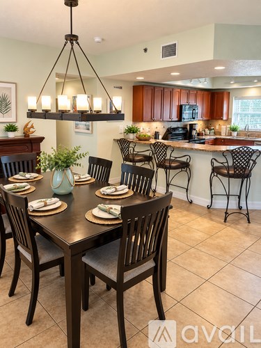 A dining room with a table set for six.