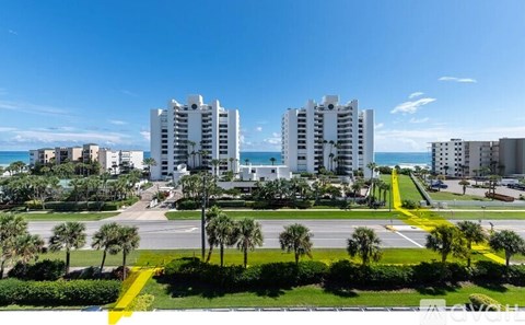 A view of a residential area with palm trees and buildings.