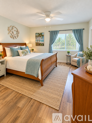 A bedroom with a large bed and a ceiling fan.