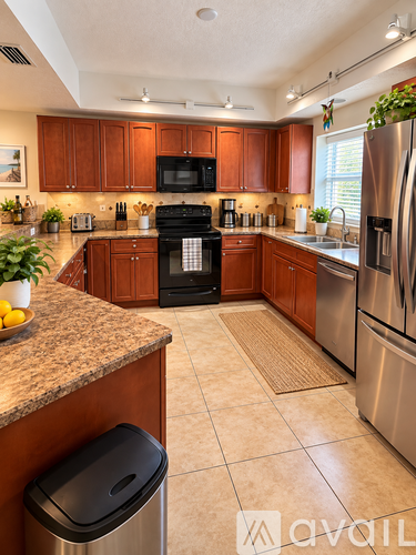 A kitchen with a black oven and stainless steel appliances.
