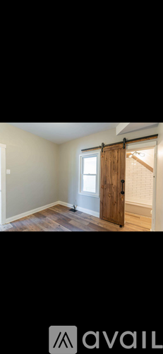 A room with a wooden door and a window.