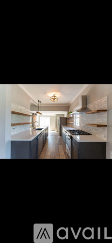 A modern kitchen with dark wood cabinets and white countertops.