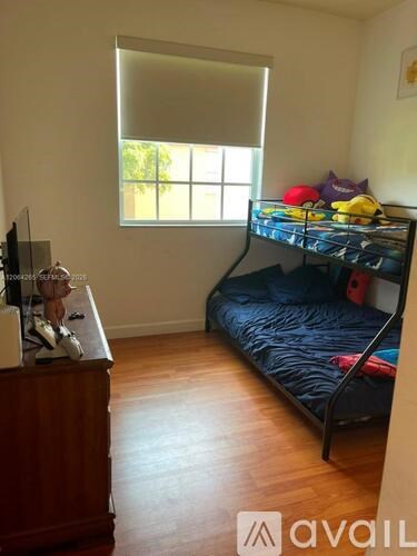A bedroom with a bunk bed and a dresser.