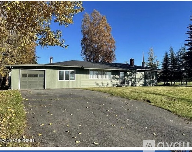 A house with a grey roof and a garage door.