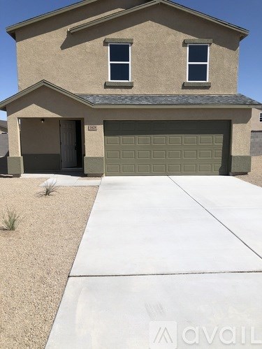 A house with a garage and a driveway in front.