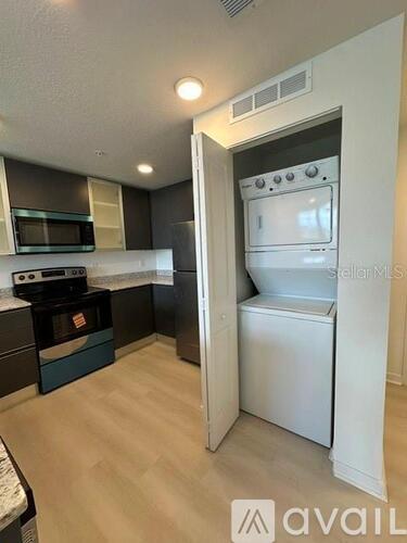 A small kitchen with a white oven and microwave.
