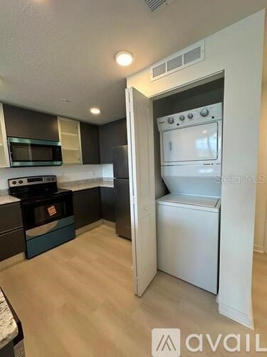 A small kitchen with a white oven and microwave.