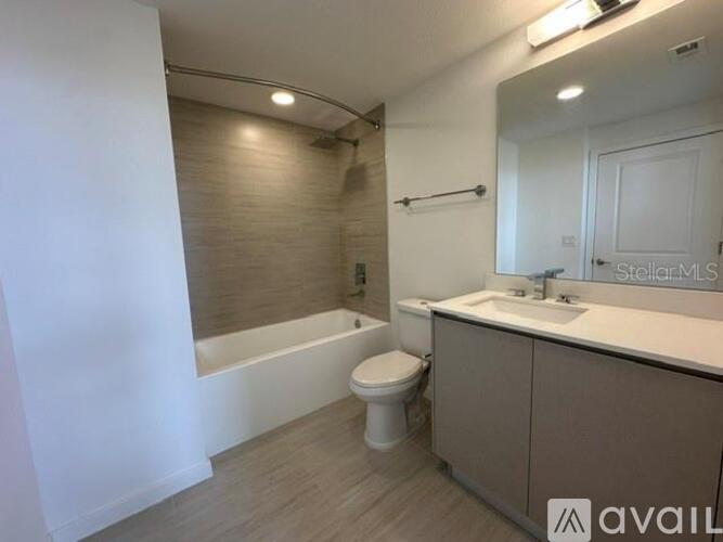 A bathroom with a toilet, sink, and bathtub.