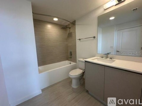 A bathroom with a toilet, sink, and bathtub.