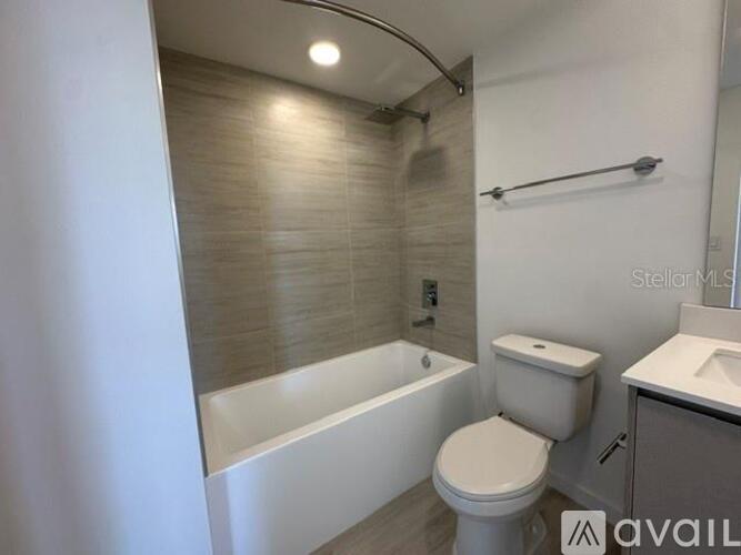 A bathroom with a toilet, sink, and bathtub.