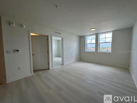 A spacious room with a window and a door.