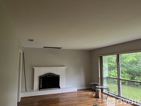 A living room with a fireplace and a table.