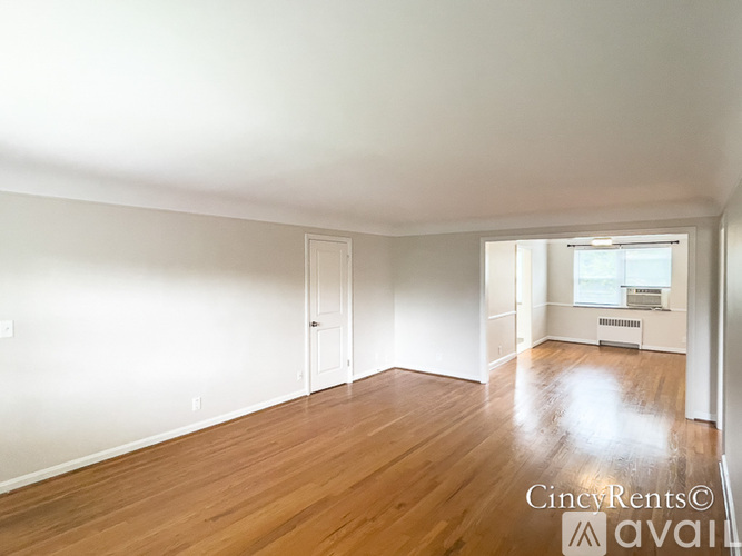 A room with wooden floors and white walls.