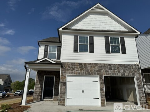 A two-story house with a white garage door.