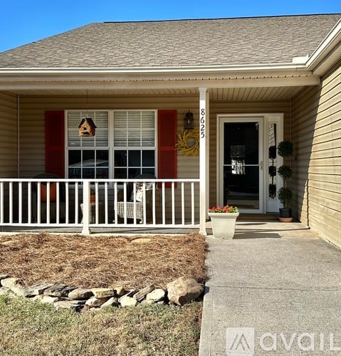 A house with a porch and a door with a number 8000 on it.