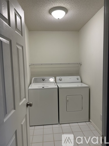 A small laundry room with a washer and dryer.