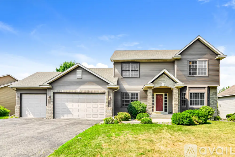 A two-story house with a garage is for sale.
