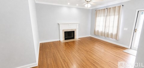 A room with a fireplace and wooden floors.