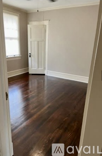 A room with wooden floors and a white door.
