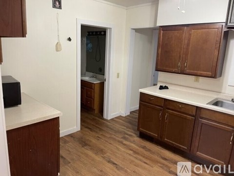 A kitchen with brown cabinets and a white countertop.