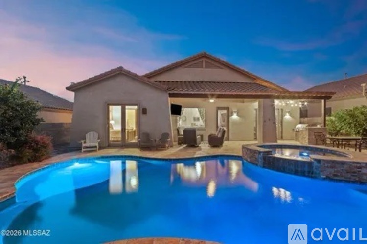 A house with a pool in front of it is available for sale.