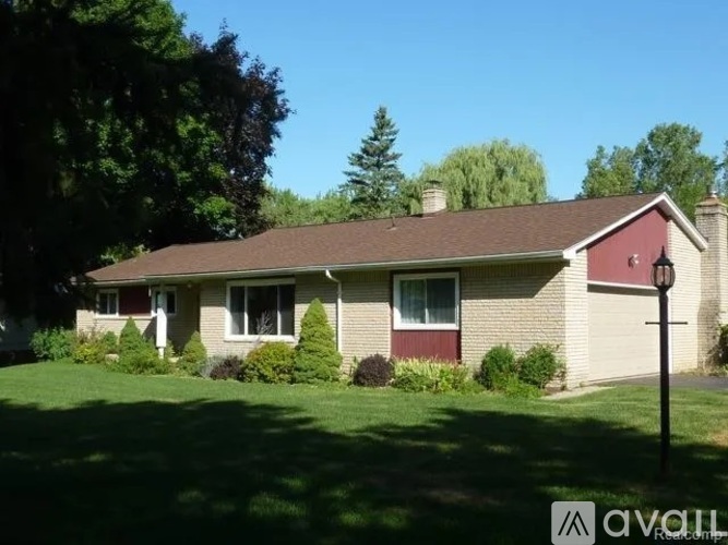 A house with a red roof and a white garage door.
