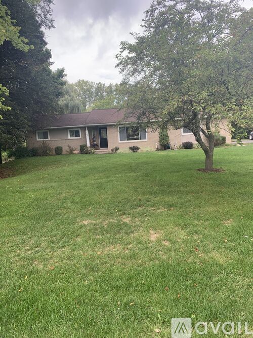 A house with a tree in front of it.