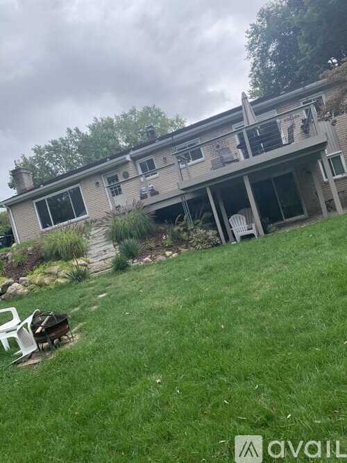 A house with a lawn and a patio table.