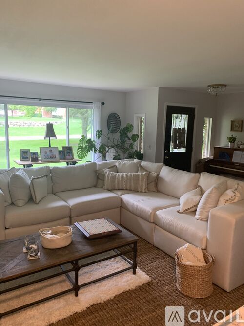 A living room with a white couch and a coffee table.