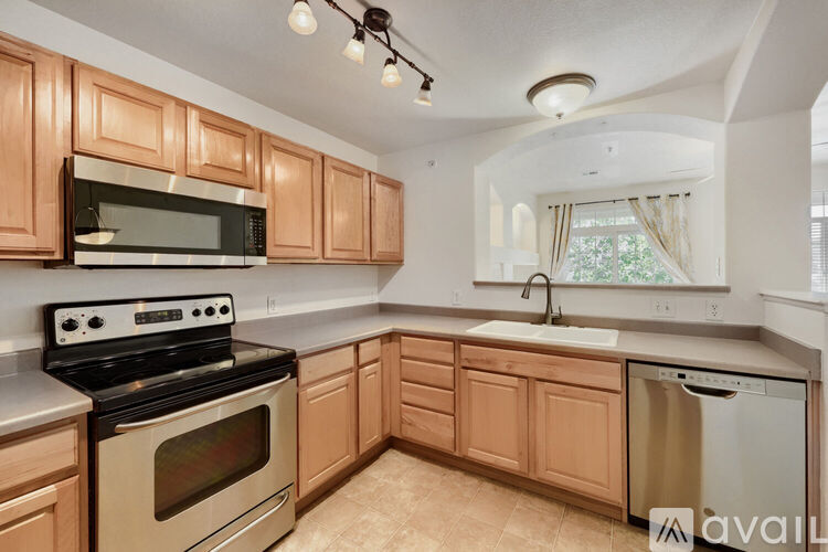 A kitchen with wooden cabinets and a black stove top oven.