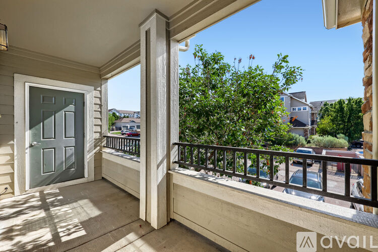 A balcony with a glass door and a metal railing.