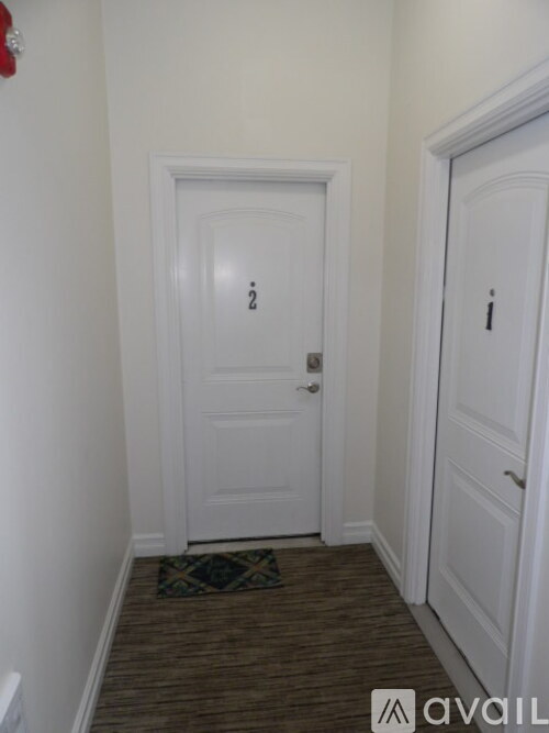 A hallway with a door on the left and a door on the right.