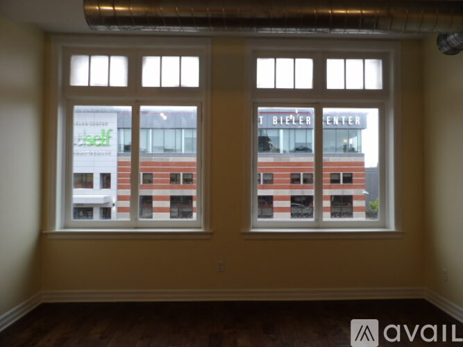 A room with a large window overlooking a building with the words "BIELE" on it.