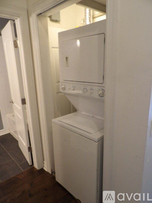A white oven and microwave built into a kitchen wall.
