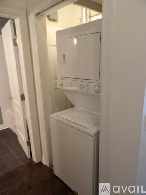 A white oven and microwave built into a kitchen wall.