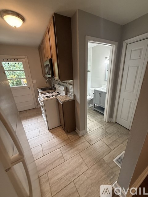 A kitchen with a dishwasher and a microwave.